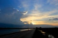 In the evening the blue sky,the sun, shining golden light behind the clouds are gradually moving down view of the street Royalty Free Stock Photo