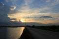 In the evening the blue sky,the sun, shining golden light behind the clouds are gradually moving down view of the street Royalty Free Stock Photo