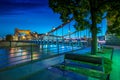 Evening on the boulevards on the Oder river in WrocÃâaw. Illuminated historic buildings and bridges. Beautiful sky and reflections