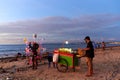 Evening business of a vendor and his grill carts on the beach. Evening market on the beach Royalty Free Stock Photo