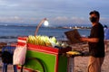 Evening business of a vendor and his grill carts on the beach. Evening market on the beach Royalty Free Stock Photo