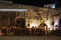 Evening cafe under the walls of the old fortress in Montenegro. Romantic atmosphere of the old city
