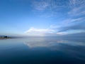 Evening calm and smooth lake surface under soft clouds Royalty Free Stock Photo