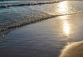 Evening calm waves in the sand. The sun is reflected in the water. Royalty Free Stock Photo