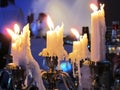 Many paraffin candles burning on a candlestick