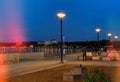 Evening city promenade people walk and relax street lamp light on pier blurred on sea water in port of Tallinn Reidi tee