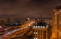 Evening cityscape. View of a large urban residential area and a wide city road. high buildings in the foreground on the right