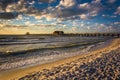 Evening clouds over the fishing pier and Gulf of Mexico in Naples, Florida. Royalty Free Stock Photo