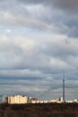 Evening clouds over houses and TV tower Royalty Free Stock Photo
