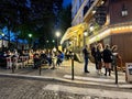 Evening diners lounge on the terrasse of the Relais de la Butte, Montmartre, Paris, France Royalty Free Stock Photo