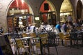 Evening diners relax in an outdoor restaurant