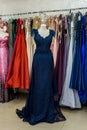Evening dresses hang on a shelf in store Royalty Free Stock Photo