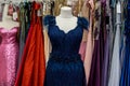 Evening dresses hang on a shelf in store Royalty Free Stock Photo