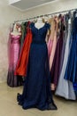 Evening dresses hang on a shelf in store Royalty Free Stock Photo