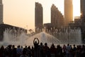 The evening Dubai Fountain show with audience with the theatre in the background