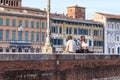 Evening on the embankment of the Arno river in Pisa, Italy