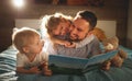 evening family reading. father reads children . book before going to bed . Royalty Free Stock Photo