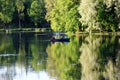 Evening Gatchina Park is lit by the summer sun.Family swims on a boat on the lake.