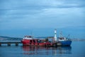 Evening at the Harbor: Red Fishing Boat and Sailboats Royalty Free Stock Photo