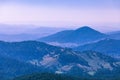 Evening haze over forested hills and mountains.