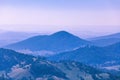 Evening haze over forested hills and mountains.