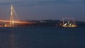 Evening image of sea bay with ship, bridge