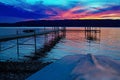 Evening at the Lake with Dock Prominent and Boat in Foreground, Keuka Lake, Penn Yan, New York, August, 2012 Royalty Free Stock Photo