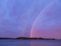Evening lake island landscape with double rainbow