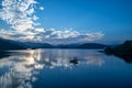 The evening lake reflected the sunset glow and mountains Royalty Free Stock Photo