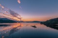 The evening lake reflected the sunset glow and mountains Royalty Free Stock Photo