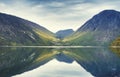 Evening landscape of Norway fjord in calm with reflection of mountains and sky in calm water Royalty Free Stock Photo