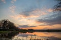 Evening landscape over the pond with several trees and branches Royalty Free Stock Photo