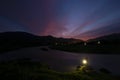 The evening landscape, the river, the mountains, the dark blue sky, and my shadow holding the light in my hand