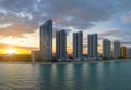 Evening landscape of sandy beachfront in Sunny Isles Beach city with luxurious highrise hotels and condo buildings on Royalty Free Stock Photo