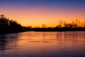 Evening landscape after sunset. Beautiful colorful sky over a frozen pond Royalty Free Stock Photo