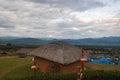 Evening landscape with traditional Thai house in the foreground from Yun Lai Viewpoint in Pai, Thailand