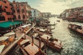 Evening light over Venice with bars, water taxi boats, travelers and Grand Canal. Historical italian city