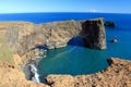 Large Rock Arches jutting into the Atlantic Ocean, Dyrholaey in Evening Sun, South Coast of Iceland Royalty Free Stock Photo