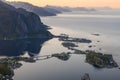 Reine\'s interconnected isles reflect in fjord, under Lofoten\'s evening light