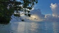 Evening in the Maldives. The sun shines through the picturesque cumulus clouds.