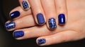 Evening manicure, design cold colors, blue gel polish with silver ribbons and pattern Royalty Free Stock Photo