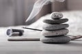 Evening meditation at home. Pyramid of zen stones, burning incense stick next to watch lying on white wooden table in Royalty Free Stock Photo