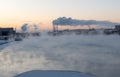 Evening mist above river and industrial pipes with smoke, St.Petersburg