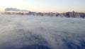 Evening mist above river and industrial pipes with smoke, St.Petersburg