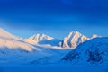 Evening mountain. White snowy mountain peak, blue glacier Svalbard, Norway. Ice in ocean. Iceberg in North pole. Beautiful landsca Royalty Free Stock Photo