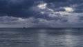 Evening in the ocean. The yacht is visible on the calm turquoise water Royalty Free Stock Photo