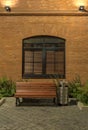 Evening in the old quarter. Office building in loft style. Brick building with large Windows, bench and an urn.