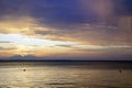 Evening over the sea. Colorful sunset. A bright red sun sets behind a mountain in the clouds. Sithonia. Greece .