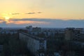 Evening panorama of the city overlooking residential areas against the backdrop of the sunset sky and clouds.