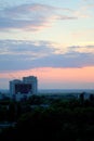 Evening panorama of the city of Togliatti overlooking residential areas, a brick house under construction and a tower crane. Royalty Free Stock Photo